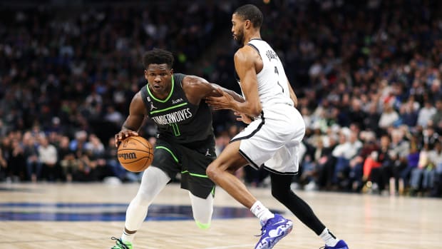 Timberwolves guard Anthony Edwards (1) drives while Nets forward Mikal Bridges (1) defends during a game.